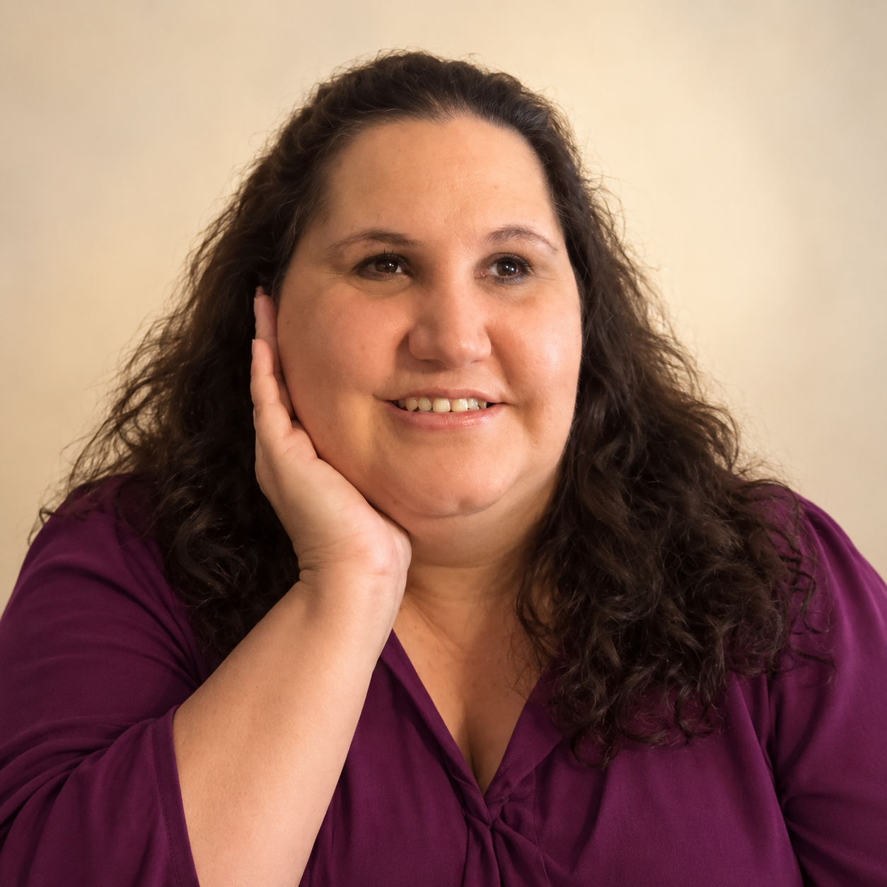 Author Lorna Sotelo wearing a plum-purple blouse